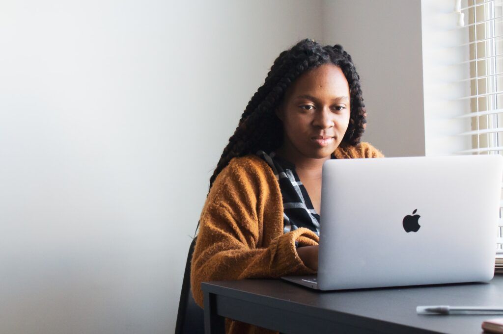 Woman Typing on Computer Virtual Job Interview