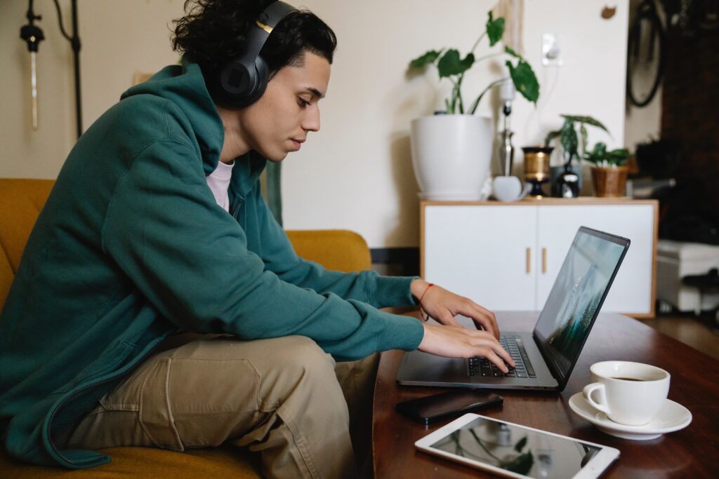 Man Work from home on Computer with Headphones