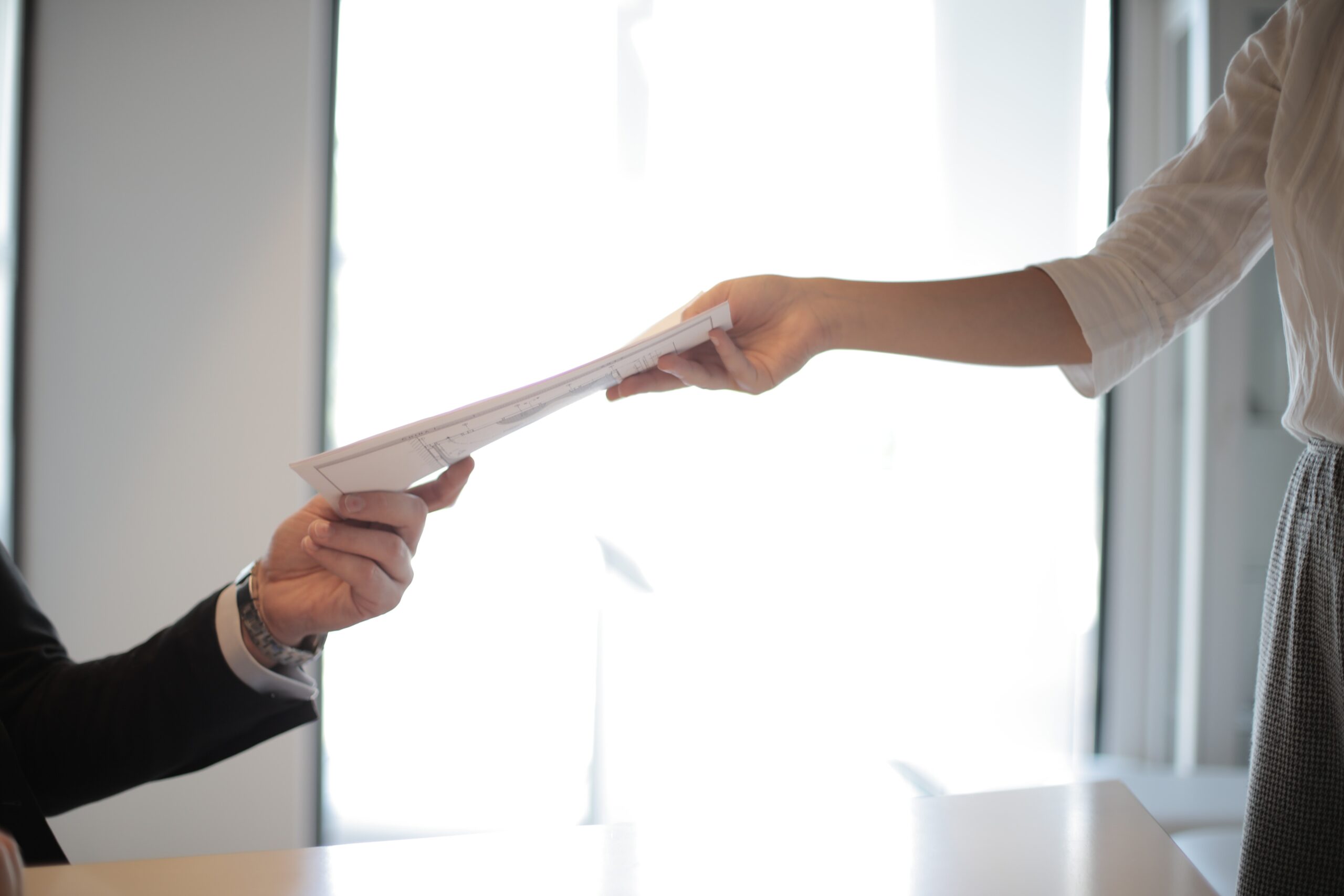 Hands holding paper resume