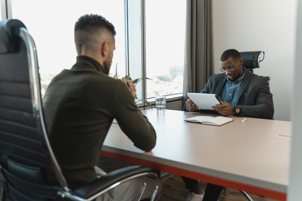 Two men reviewing a document resume