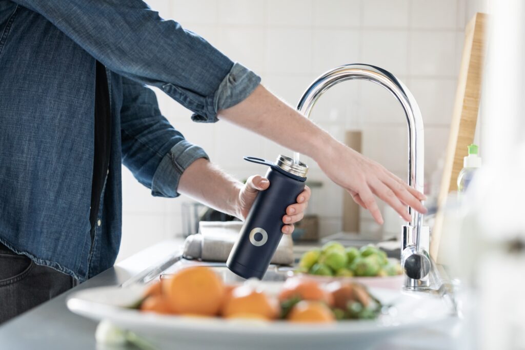 Man Filling a Water Bottle