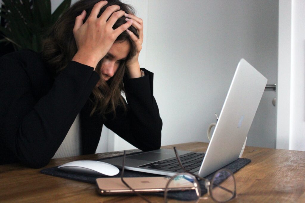 Work motivation woman looking at laptop in frustration