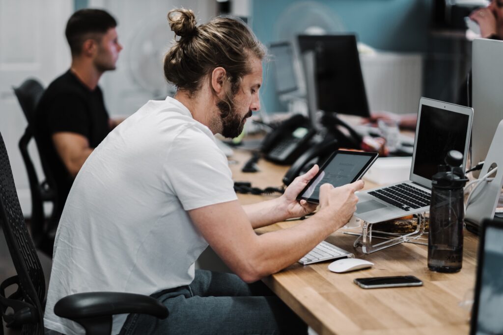 Man stressed while at work on tablet