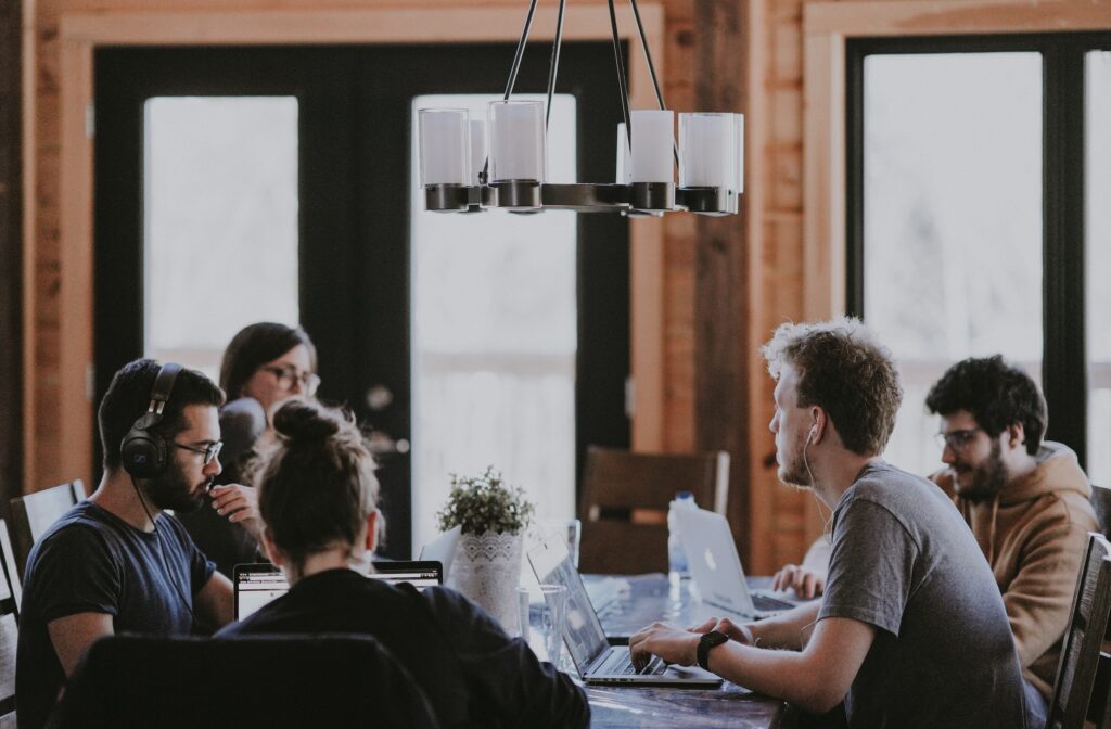 Group of people working on laptops at a table