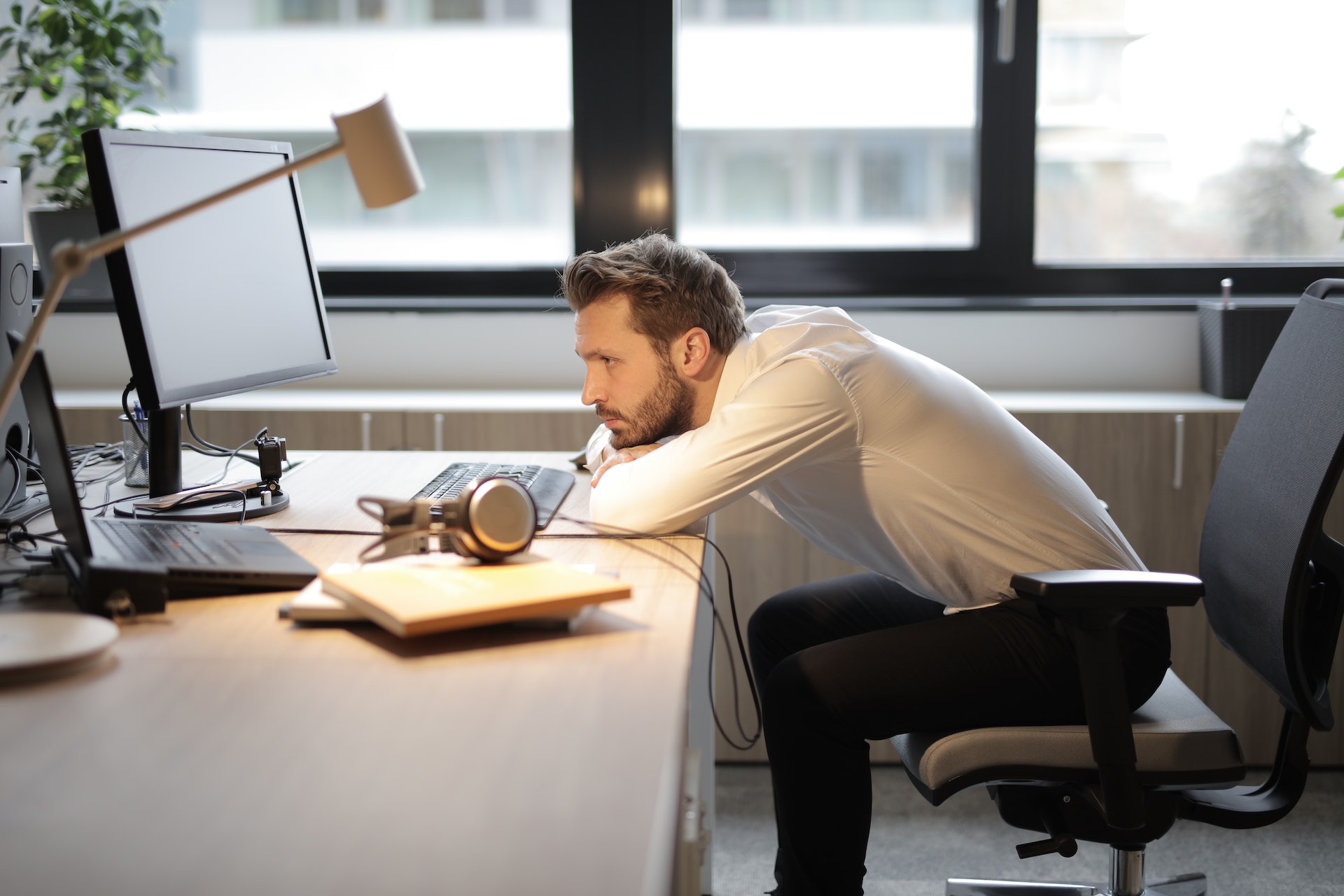 a man leaning on a desk career change