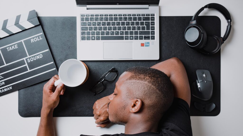 Man stressed burnout with his head laying on a desk