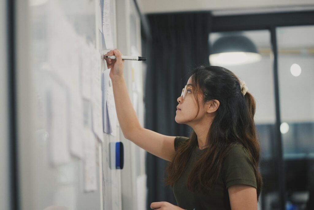 girl writing on a board working