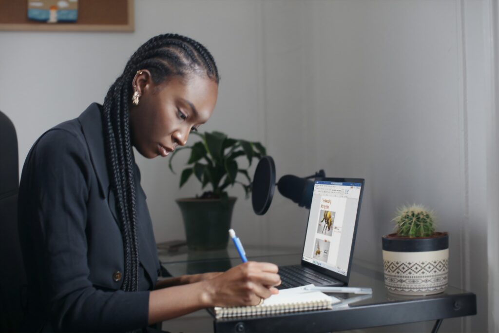 Woman writing in a notebook keywords