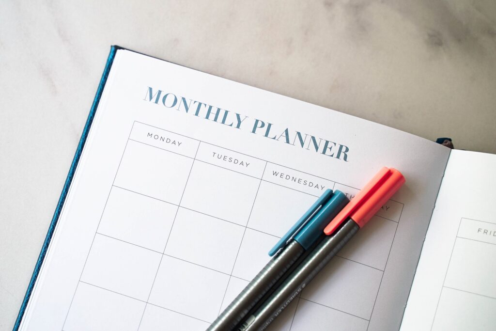 work from home schedule monthly planner calendar close up pens