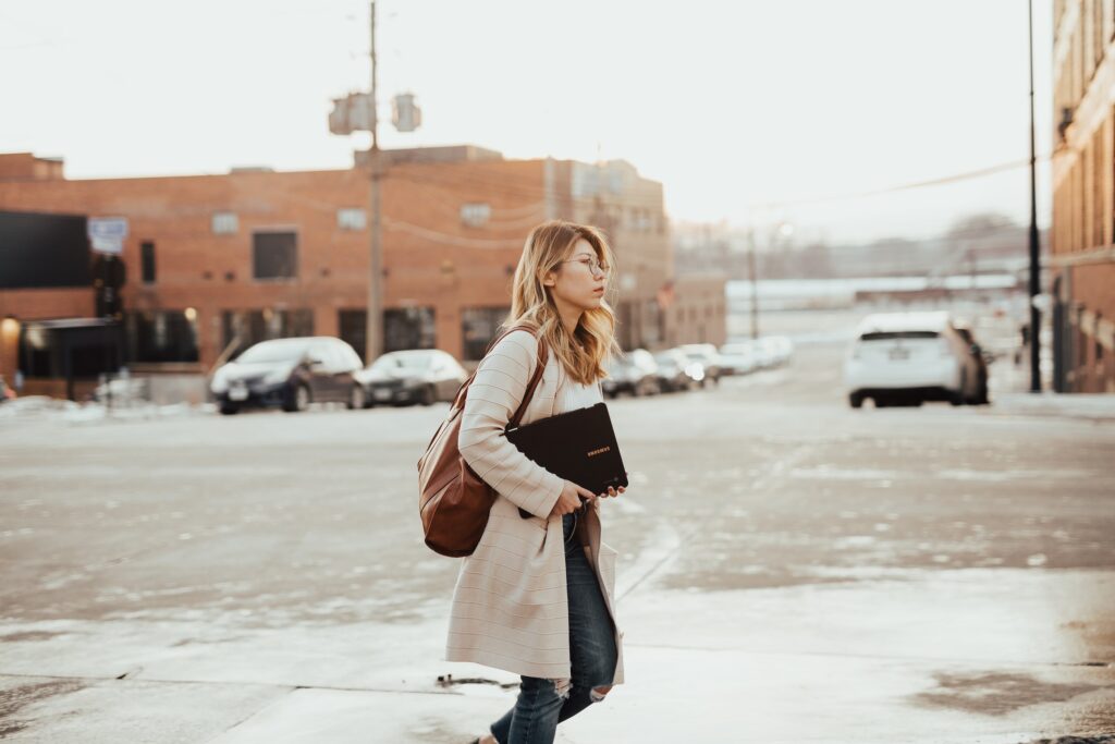 Woman Walking with a Laptop Passion Career