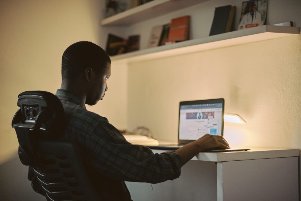 Man Sitting at a Desk on a Laptop