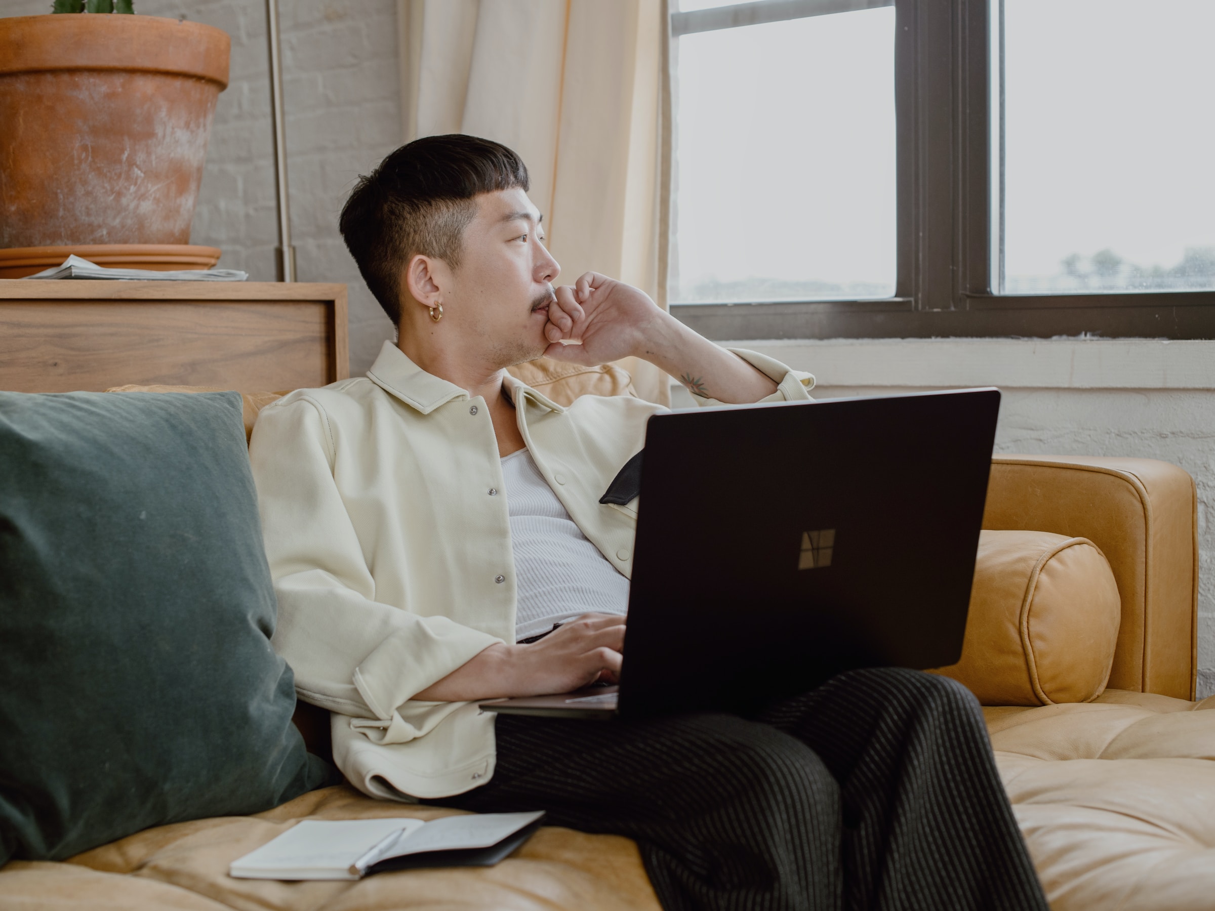 Career Coaching man sitting on a couch looking off