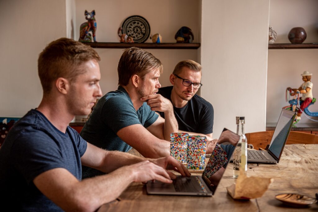 a group of guys looking stressed while working