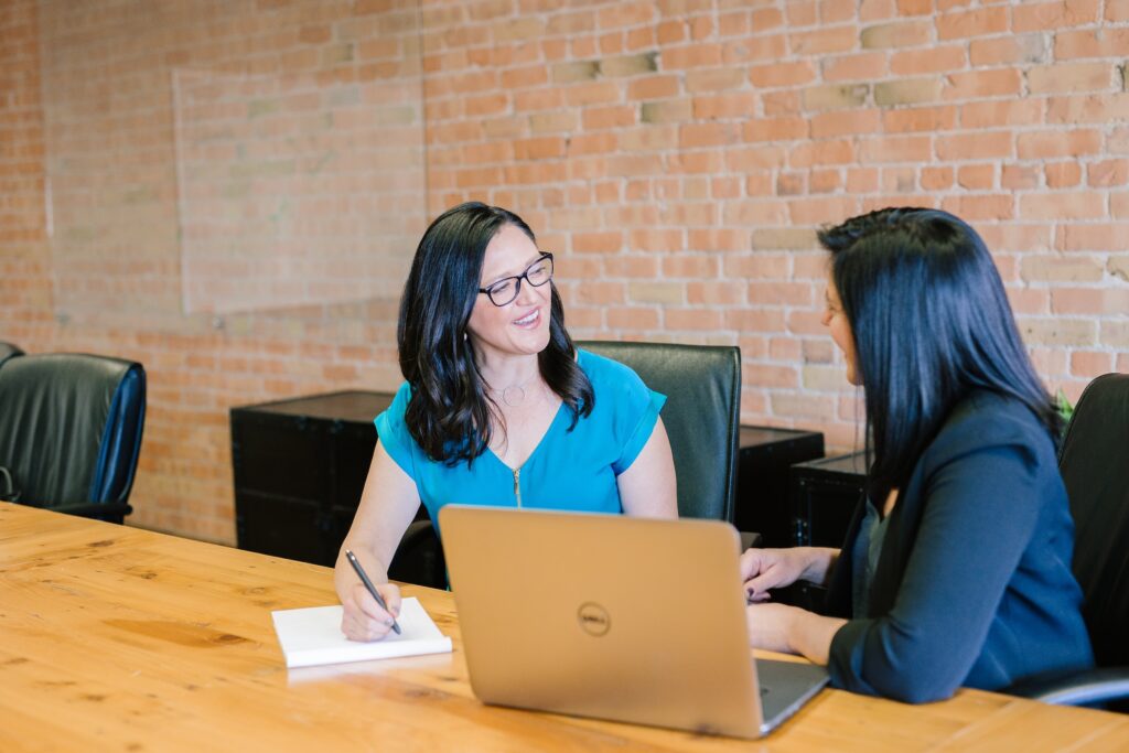 Two women talking working