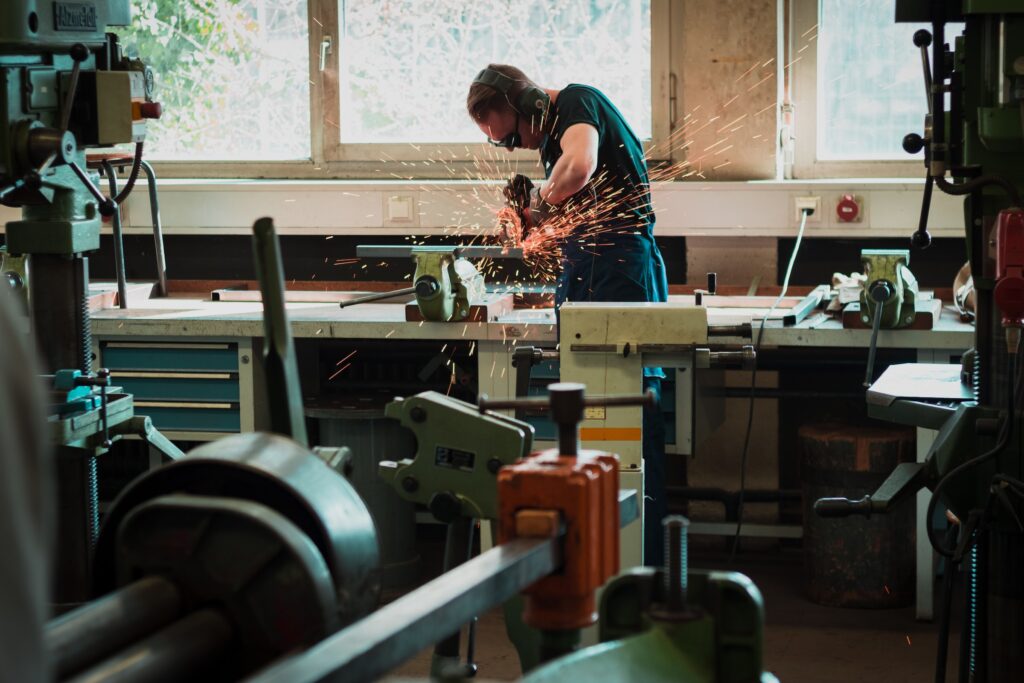 Man Welding or Sawing Metal