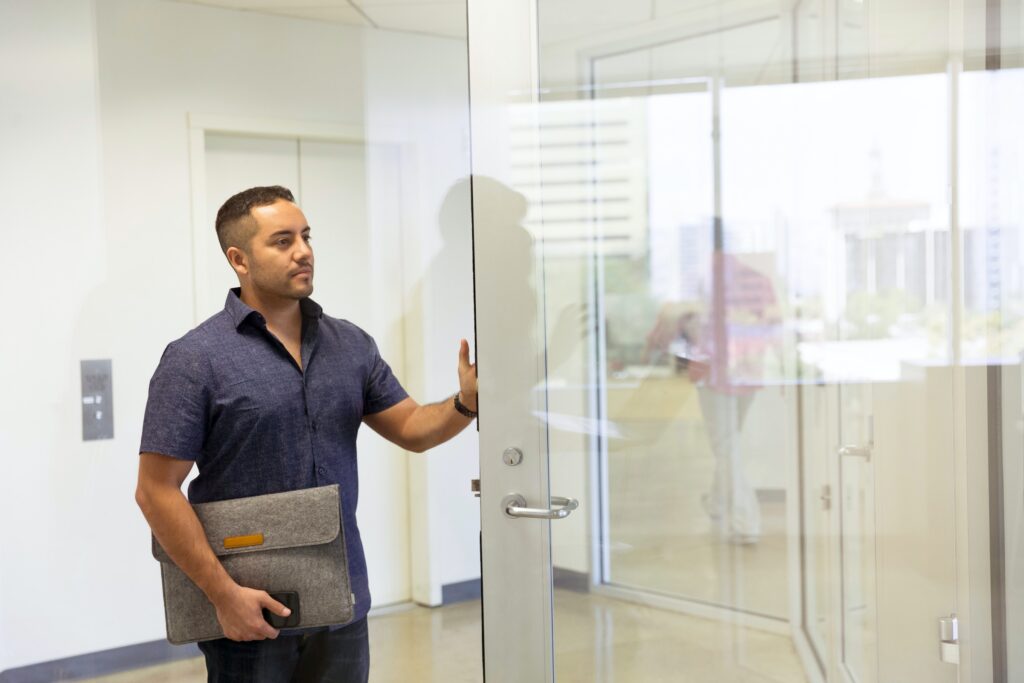 Career Coaching man walking with a laptop bag