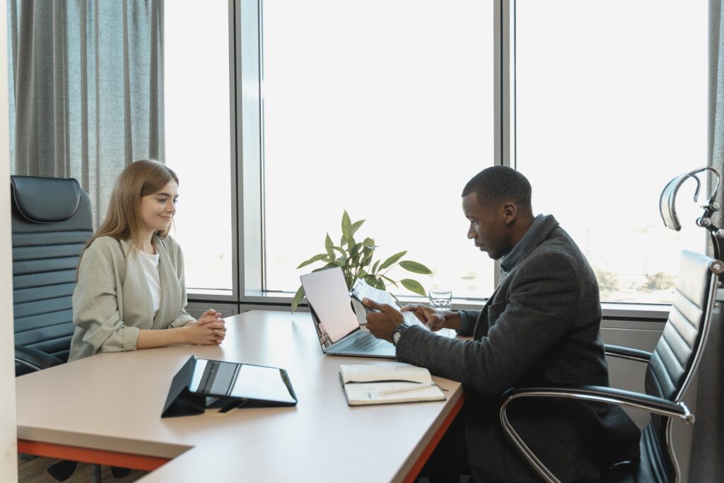 man interviewing woman resume