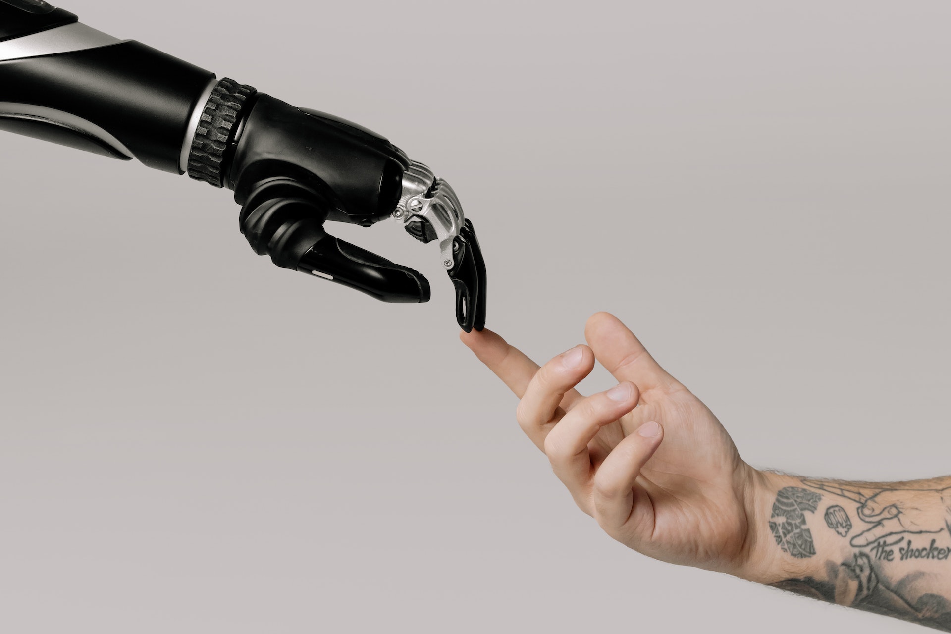 robot hand human hand touching ai