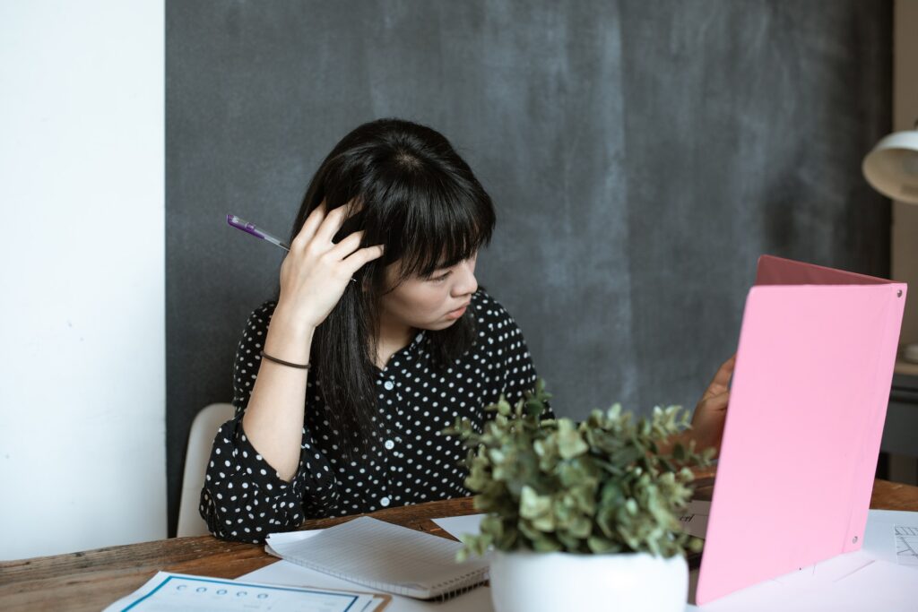 woman at work looking at an open binder