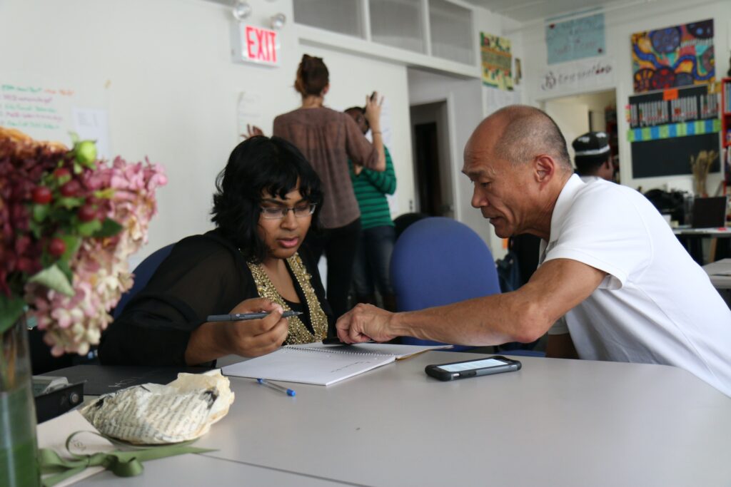 Man and Woman Writing things down writing a resume