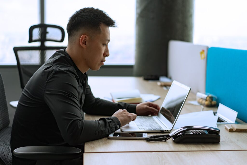 man typing on a computer