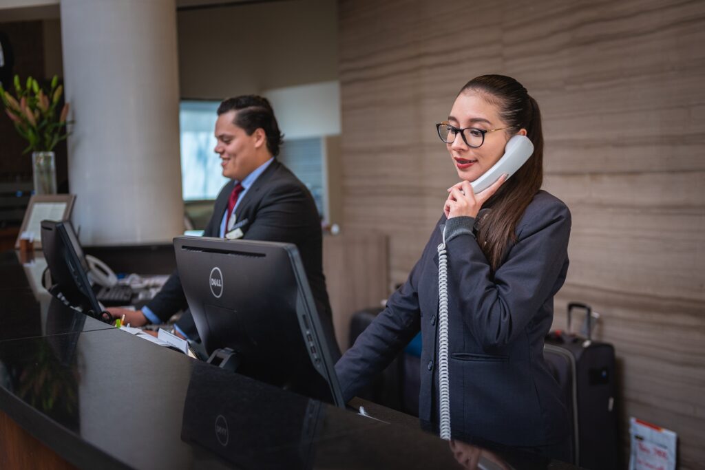 receptionists working at front desk on the phone