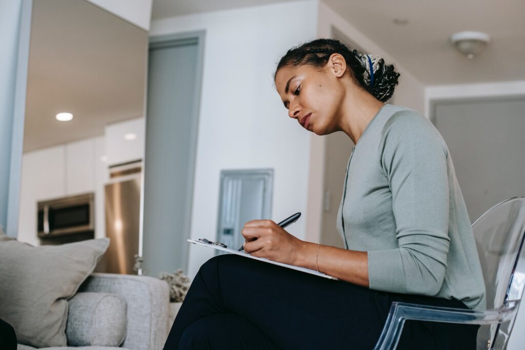 woman taking notes on a clipboard