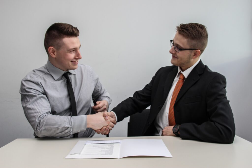 Career Service Two guys shaking hands business handshake