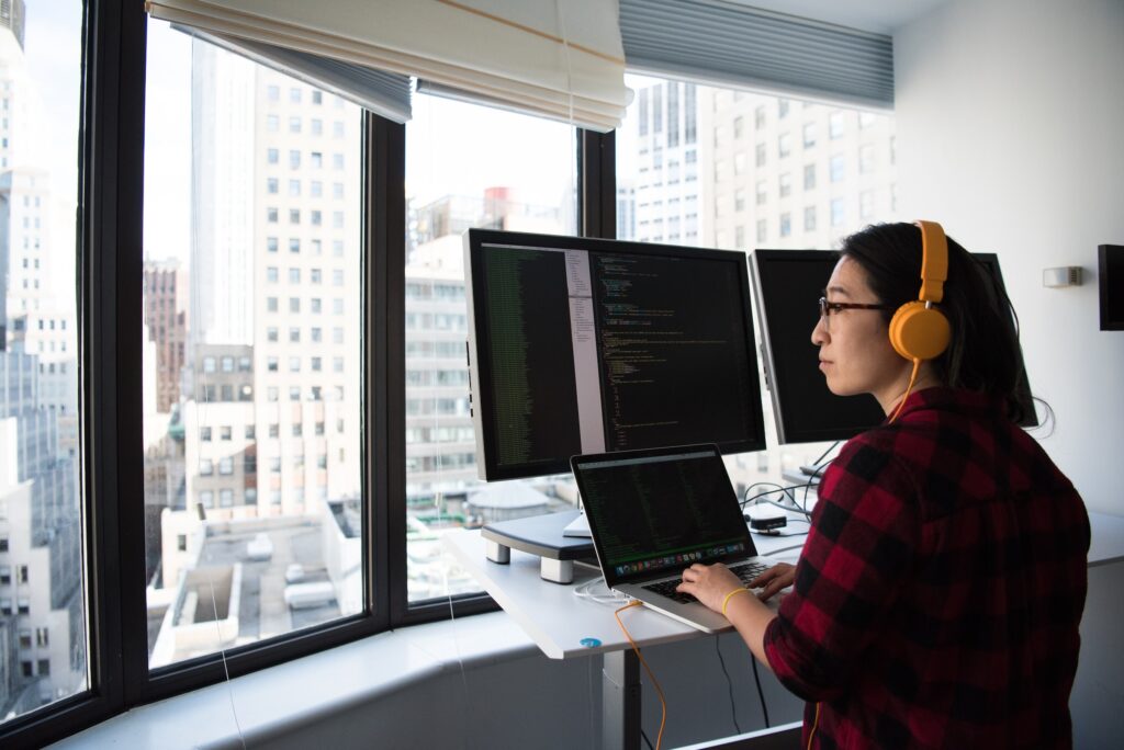 woman career service standing at desk computer working