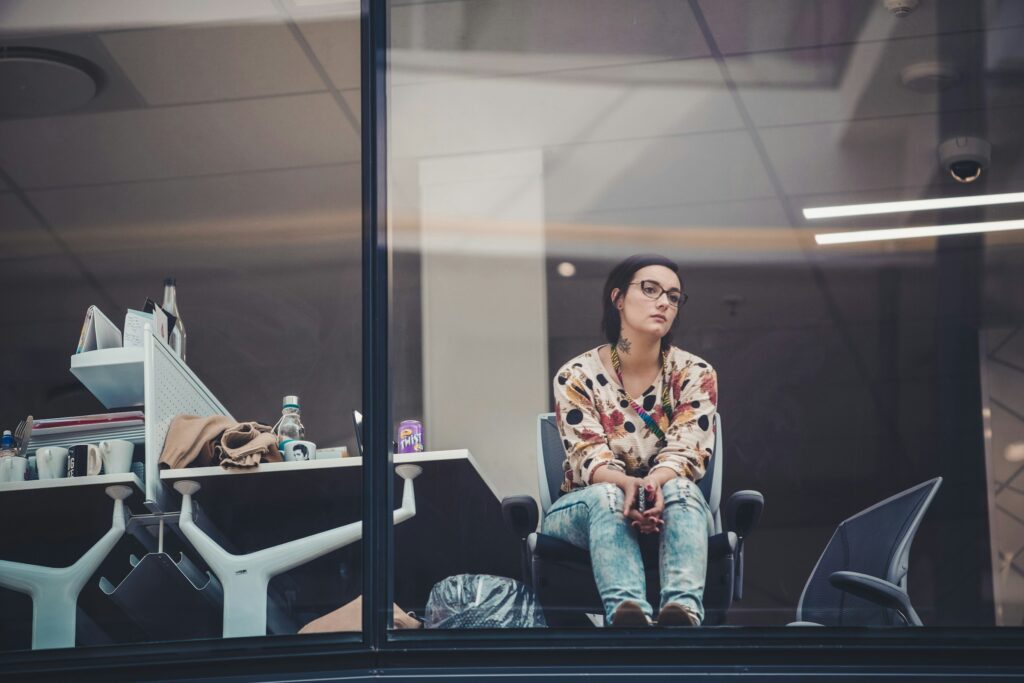 woman at work looking out a window