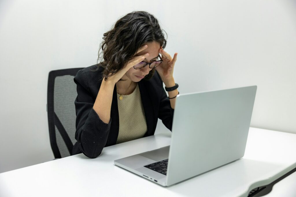 woman stressed looking at a laptop outplacement services
