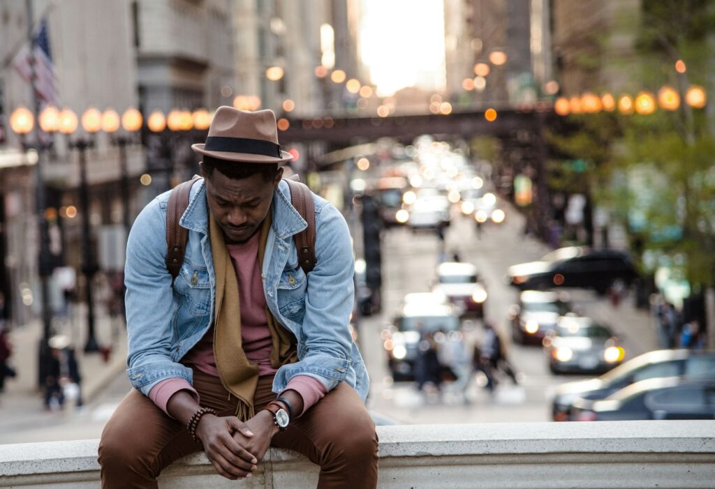 man sitting in a city 